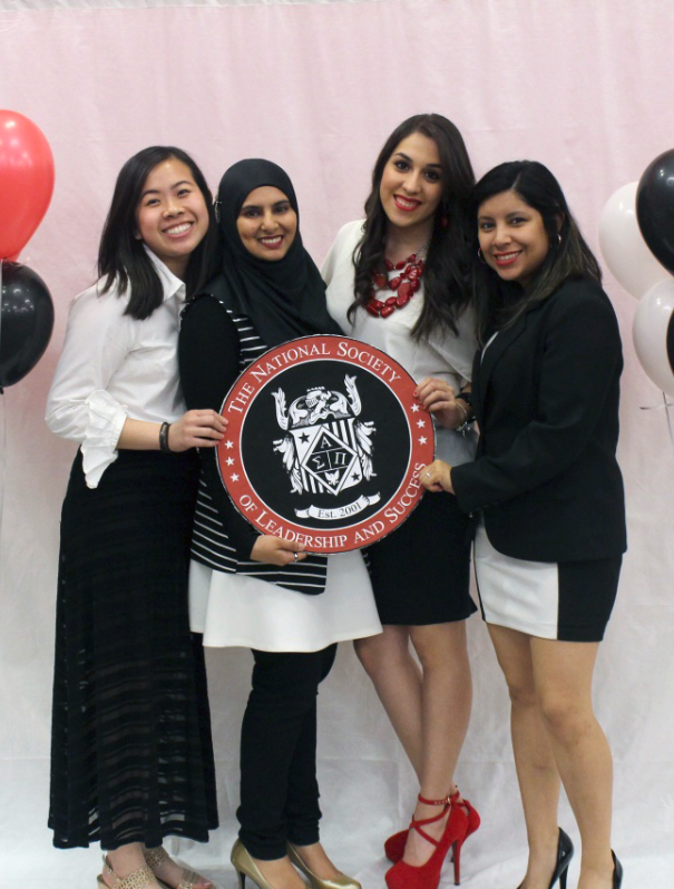 Students holding the seal of NSLS